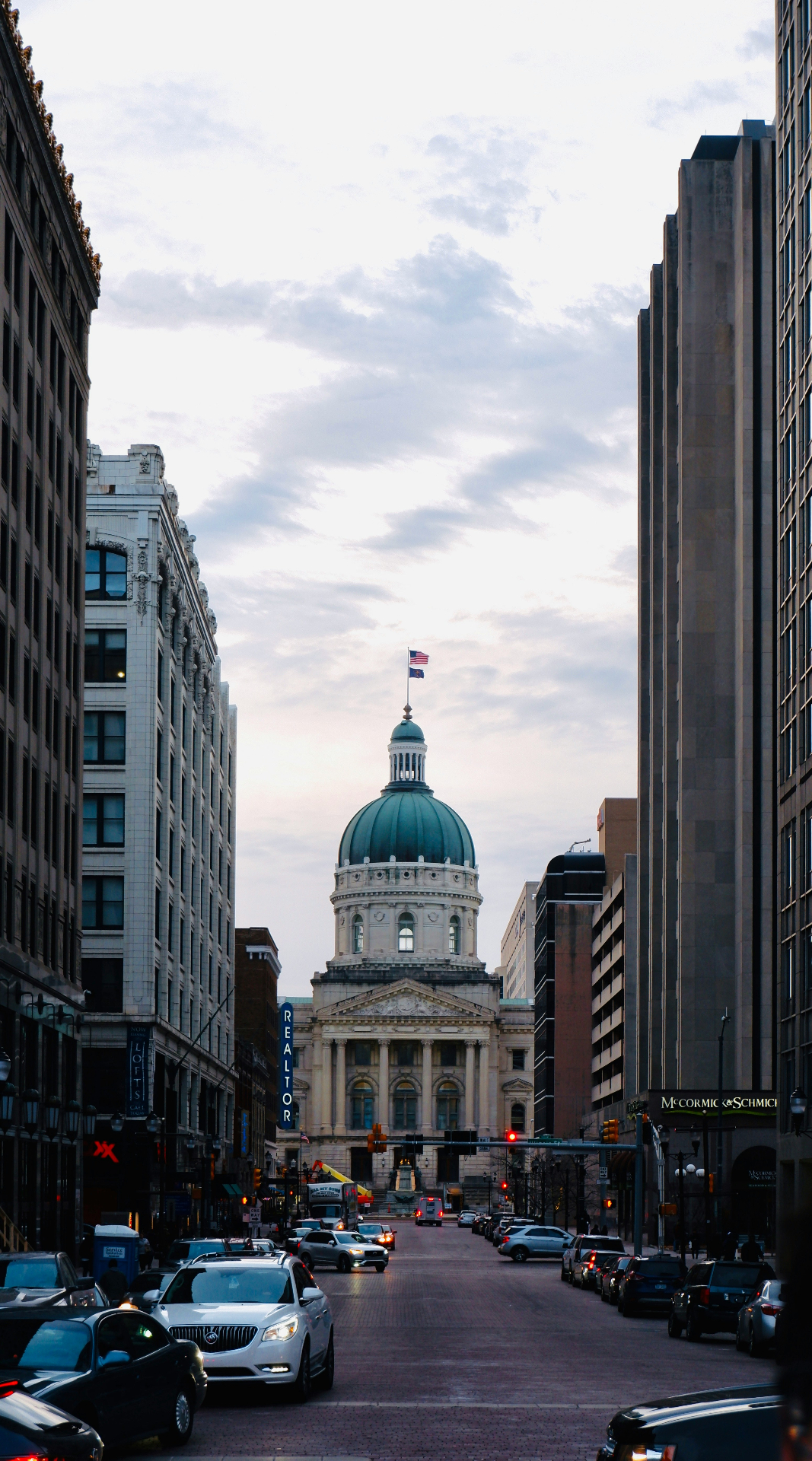 Indiana State Capitol building framed by downtown Indianapolis